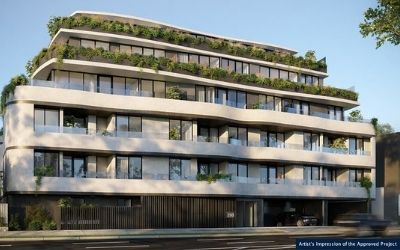 A modern multi-story apartment building with curved balconies and abundant greenery on each level, set along a street with a driveway and garage entrance on the ground floor.